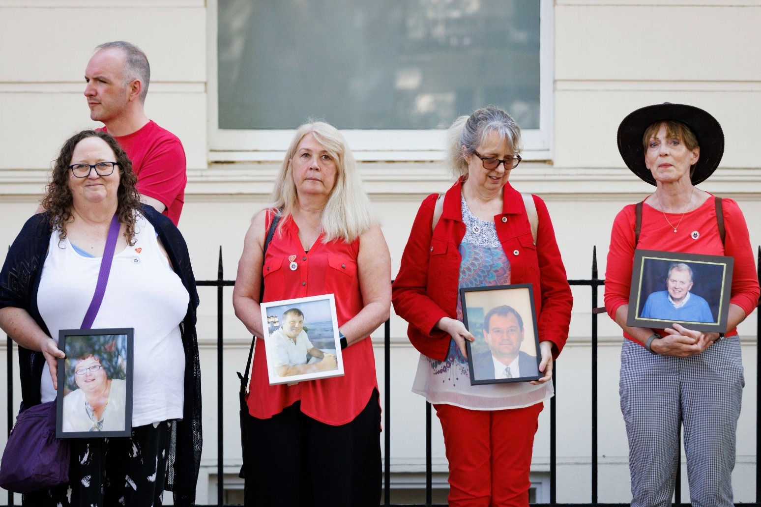 Bereaved families hold pictures of loved ones in vigil outside Covid inquiry 